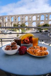 a table with plates of food on a table in front of the coliseum at Violet City Center Apartments in Kavala