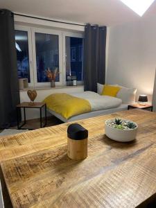 a bedroom with a bed and a table in front of it at Ferienwohnung Kleinôd Sayn in Bendorf