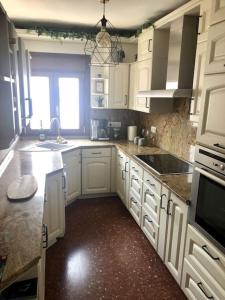a kitchen with white cabinets and a sink and a window at SB Casa Balcon De Europa, City, Nerja in Nerja