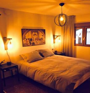 a bedroom with a large bed and a painting on the wall at SB Casa Balcon De Europa, City, Nerja in Nerja