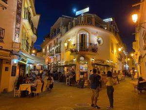 un groupe de personnes debout à l'extérieur d'un bâtiment dans l'établissement SB Casa Balcon De Europa, City, Nerja, à Nerja