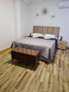 a bedroom with a bed and a wooden floor at Apartment AS in Čanj