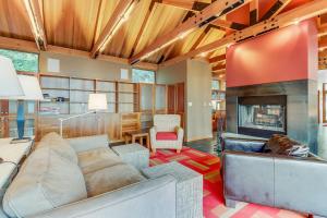 a living room with a couch and a fireplace at Fidalgo Island Waterfront Stunner in Anacortes