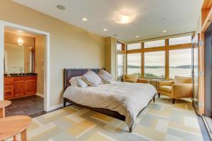 a bedroom with a bed and a table and chairs at Fidalgo Island Waterfront Stunner in Anacortes