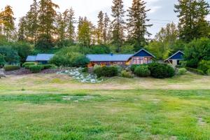 a house on a hill with a yard at Fidalgo Island Waterfront Stunner in Anacortes