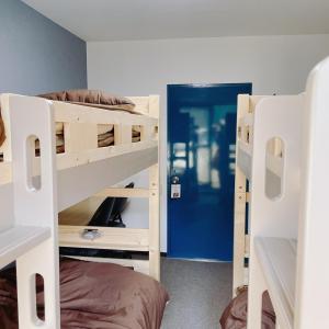 a room with two bunk beds and a blue door at Cate no mori - Vacation STAY 16675v in Shime