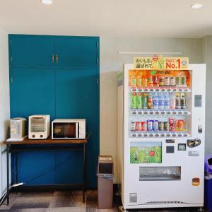 a refrigerator filled with lots of drinks and a microwave at Cate no mori - Vacation STAY 16675v in Shime