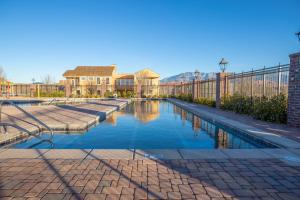 a swimming pool in front of a house at Paramount Luxury Villa with Swim Spa Sleeps 39 in Hurricane
