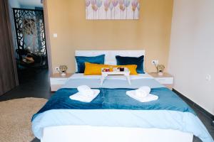 - une chambre avec un grand lit et 2 serviettes dans l'établissement Violet City Center Apartments, à Kavala
