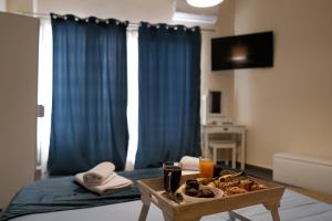 a room with a tray of food on a table at Violet City Center Apartments in Kavála