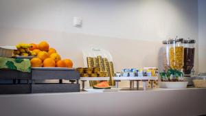 a counter with a bunch of oranges and other fruits at Hotel Lumbarda in Lumbarda