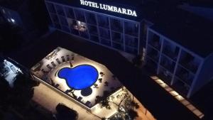 a building with a blue heart on it at night at Hotel Lumbarda in Lumbarda