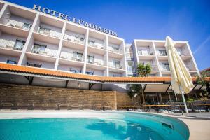 a hotel with a swimming pool in front of a hotel at Hotel Lumbarda in Lumbarda