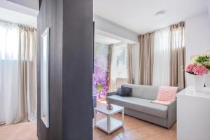 a living room with a couch and a table at Hotel Lumbarda in Lumbarda