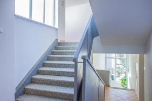 a staircase in a house with a blue railing at Hotel Lumbarda in Lumbarda