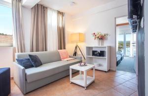 a living room with a couch and a table at Hotel Lumbarda in Lumbarda