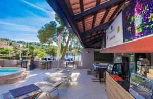 a patio with chairs and a pool and a restaurant at Hotel Lumbarda in Lumbarda