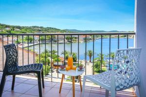 einen Balkon mit Stühlen, einem Tisch und Meerblick in der Unterkunft Hotel Lumbarda in Lumbarda