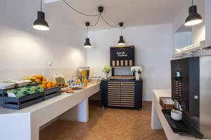 a kitchen with a counter with fruit on it at Hotel Lumbarda in Lumbarda