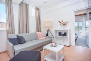 a living room with a couch and a table at Hotel Lumbarda in Lumbarda