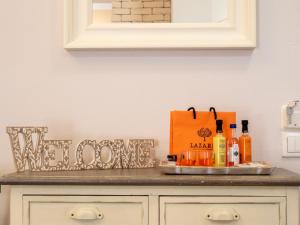 a counter with a tray with bottles of alcohol on it at Euphoria Country House in Agios Ioannis