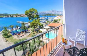 a balcony with a view of a body of water at Hotel Lumbarda in Lumbarda