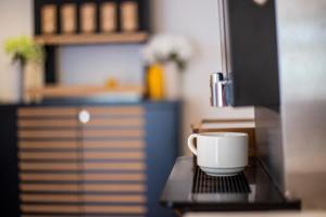 a coffee cup sitting on top of a table at Hotel Lumbarda in Lumbarda