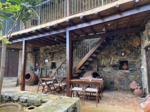 a stone building with a table and an oven at Archontiko Rousias in Nicosia