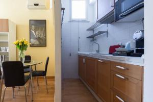 a kitchen with a table and a dining room at Domus Penna in Rome