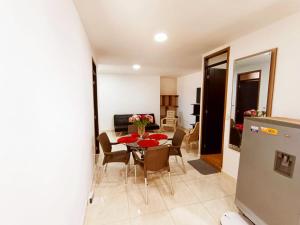 a dining room and living room with a table and chairs at Apartamentos Pitalito in Pitalito