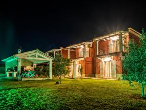 a large house at night with a gazebo at Euphoria Country House in Agios Ioannis