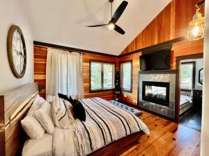 a bedroom with a bed and a clock on the wall at Highland Huckleberry Lodge in Whitefish
