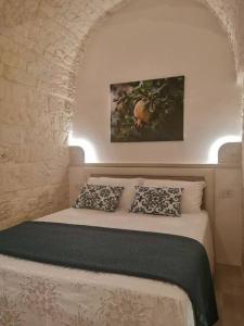 a bedroom with a bed with two pillows at A casòdd' - Luxury Suite in Ceglie Messapica +9 photos