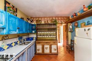 a kitchen with blue cabinets and a white refrigerator at Finca Quinta San Antonio, Girardota, Antioquia in Girardota +13 photos