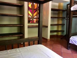 ein Schlafzimmer mit Etagenbetten und einem Buntglasfenster in der Unterkunft Finca Quinta San Antonio, Girardota, Antioquia in Girardota