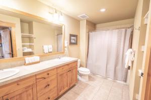 a bathroom with a sink and a toilet and a mirror at Morning Eagle 411 in Whitefish