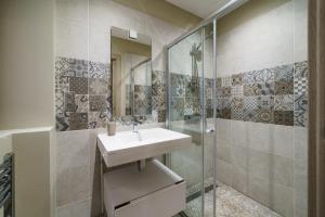 a bathroom with a sink and a shower at La cour du grand marché in Tours