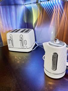 two toasters sitting on top of a table at Location, Location, Location with King Size Bed in Kent