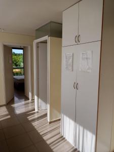 a hallway with white cabinets in a building at Chalet en Valle Grande - En Solar del Valle Country Club in Valle Grande