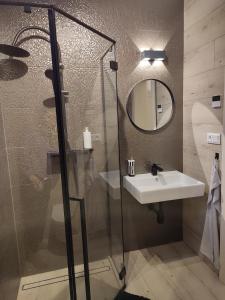 a bathroom with a sink and a mirror at Luxe chalet 79 in Ružomberok +16 photos