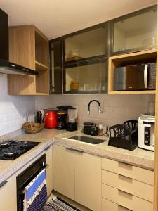 a kitchen with a sink and a counter top at Flat Carneiros in Tamandaré