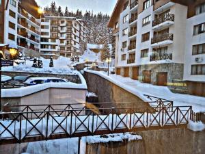 a bridge over a river with snow covered buildings at 1 bedroom luxury apartment Milena -free parking in Pamporovo