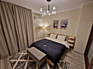 a bedroom with a bed and a chair in it at 1 bedroom luxury apartment Milena -free parking in Pamporovo