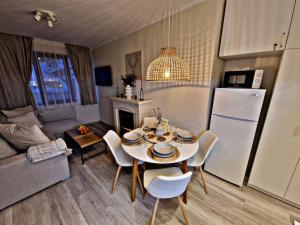 a kitchen and living room with a table and chairs at 1 bedroom luxury apartment Milena -free parking in Pamporovo