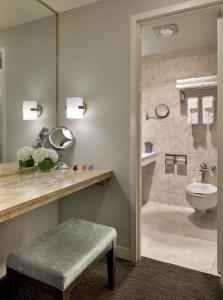a bathroom with a toilet and a sink and a shower at Handlery Union Square Hotel in San Francisco