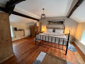 a bedroom with a bed and a wooden floor at La Fattoria in Durham