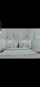 a bedroom with a large white bed with pillows at Suite Onega in Lyon