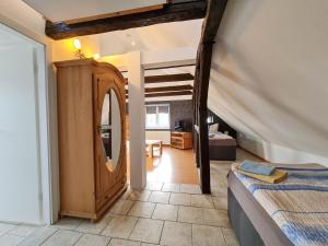 a bedroom with a mirror and a bed in a room at Pension Zum Holzwurm Wittenberge in Wittenberge