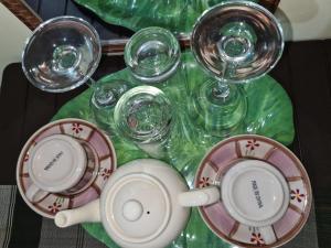 a table with cups and glasses on a table at Budget Friendly Transient in Cainta hosted by Aliyah in Cainta