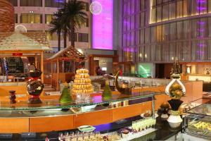 a hotel lobby with a cake on a table at Crowne Plaza Kuwait Al Thuraya City, an IHG Hotel in Kuwait